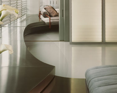 Scalloped stainless steel window ledge and bench clad to wood in private residence