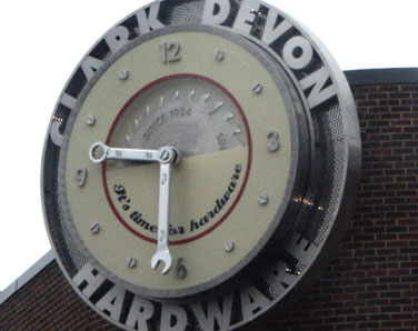 Brushed stainless steel exterior clock display for hardware retailer